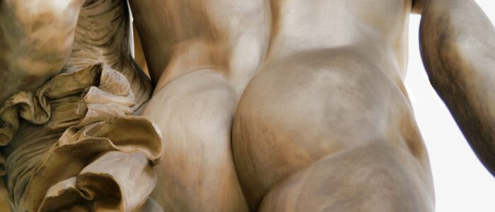 Detail of a marble statue, showcasing a male's butt